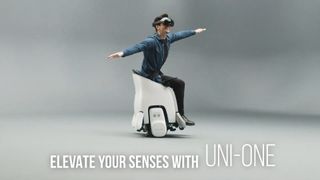 A screenshot from a YouTube video of the UNI-ONE device, with a user holding their arms out to the sides while it moves and grinning