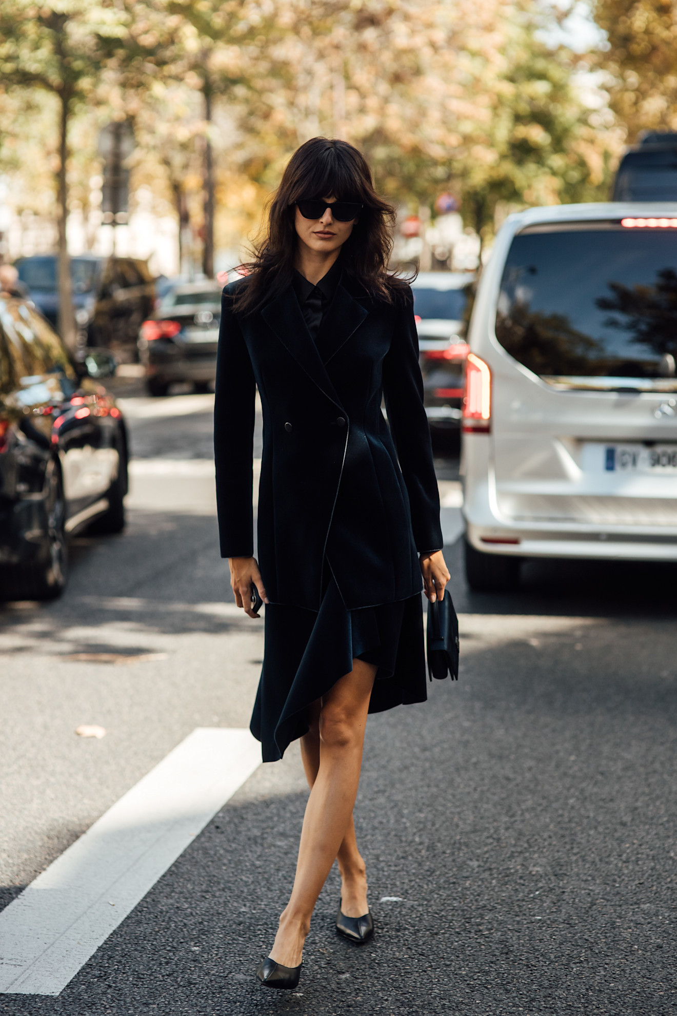 a woman wearing a black dress during paris fashion week