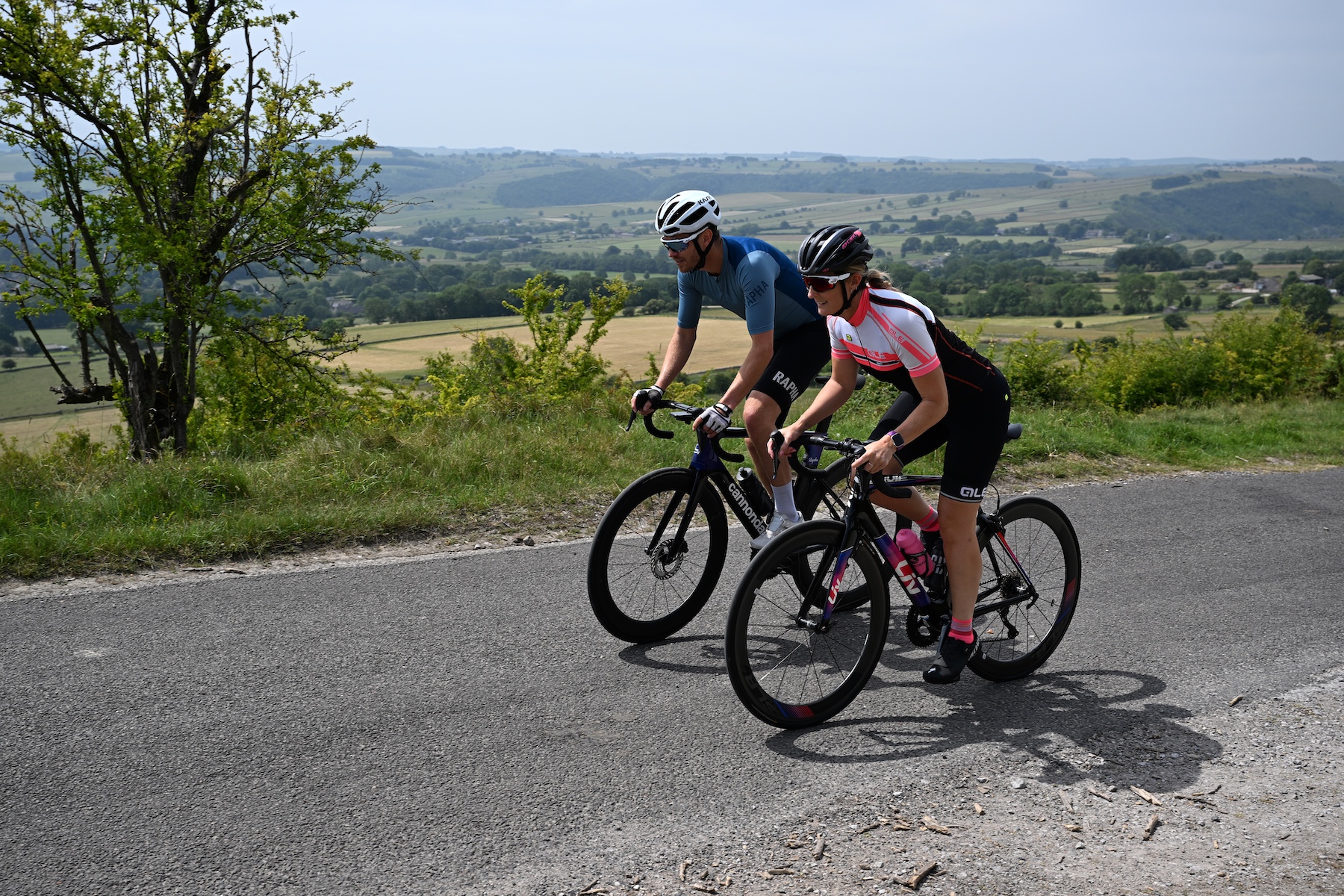 Two riders climbing out of the saddle in the countryside