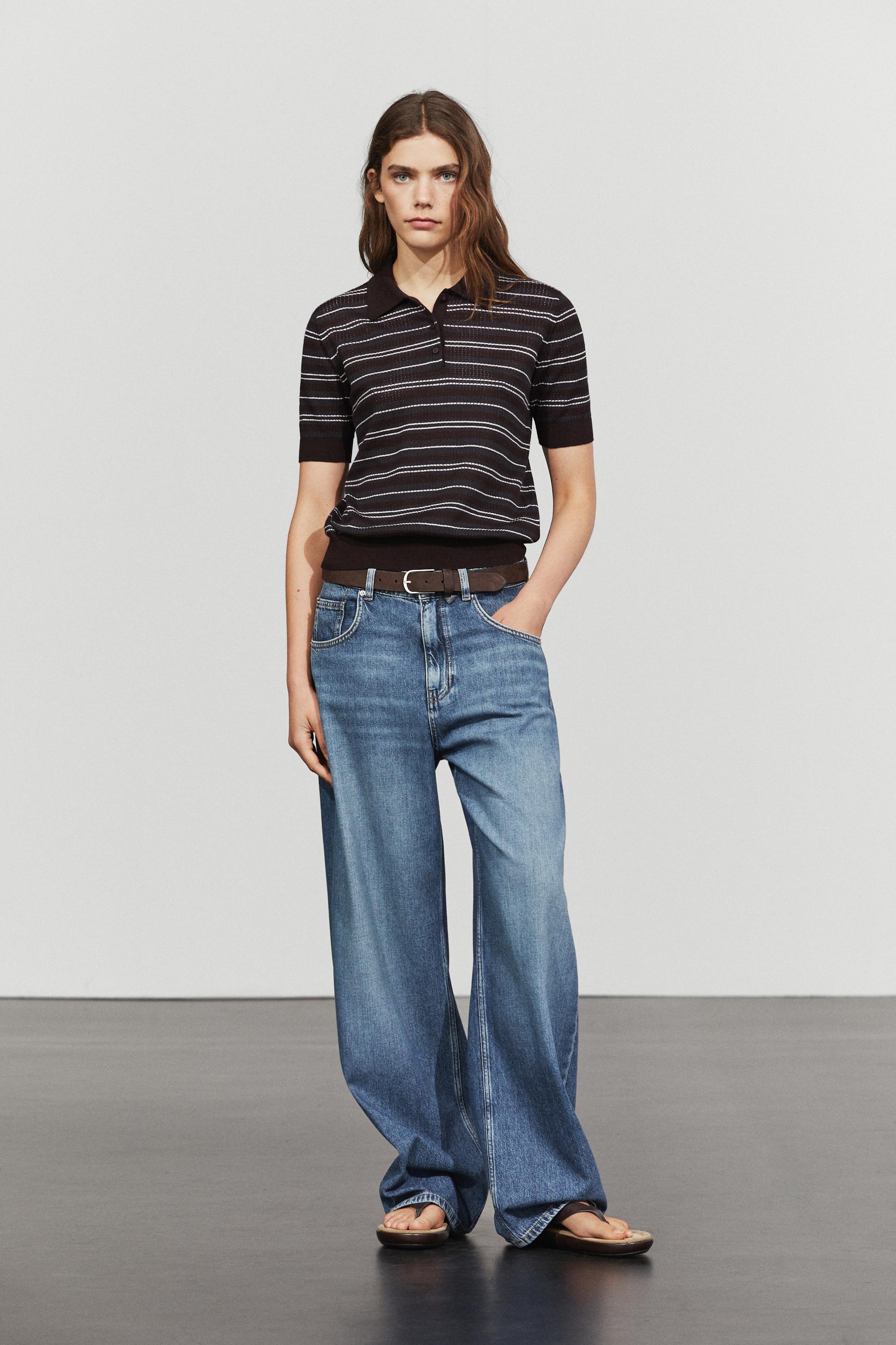 An image of a model in a striped polo T-shirt and jeans