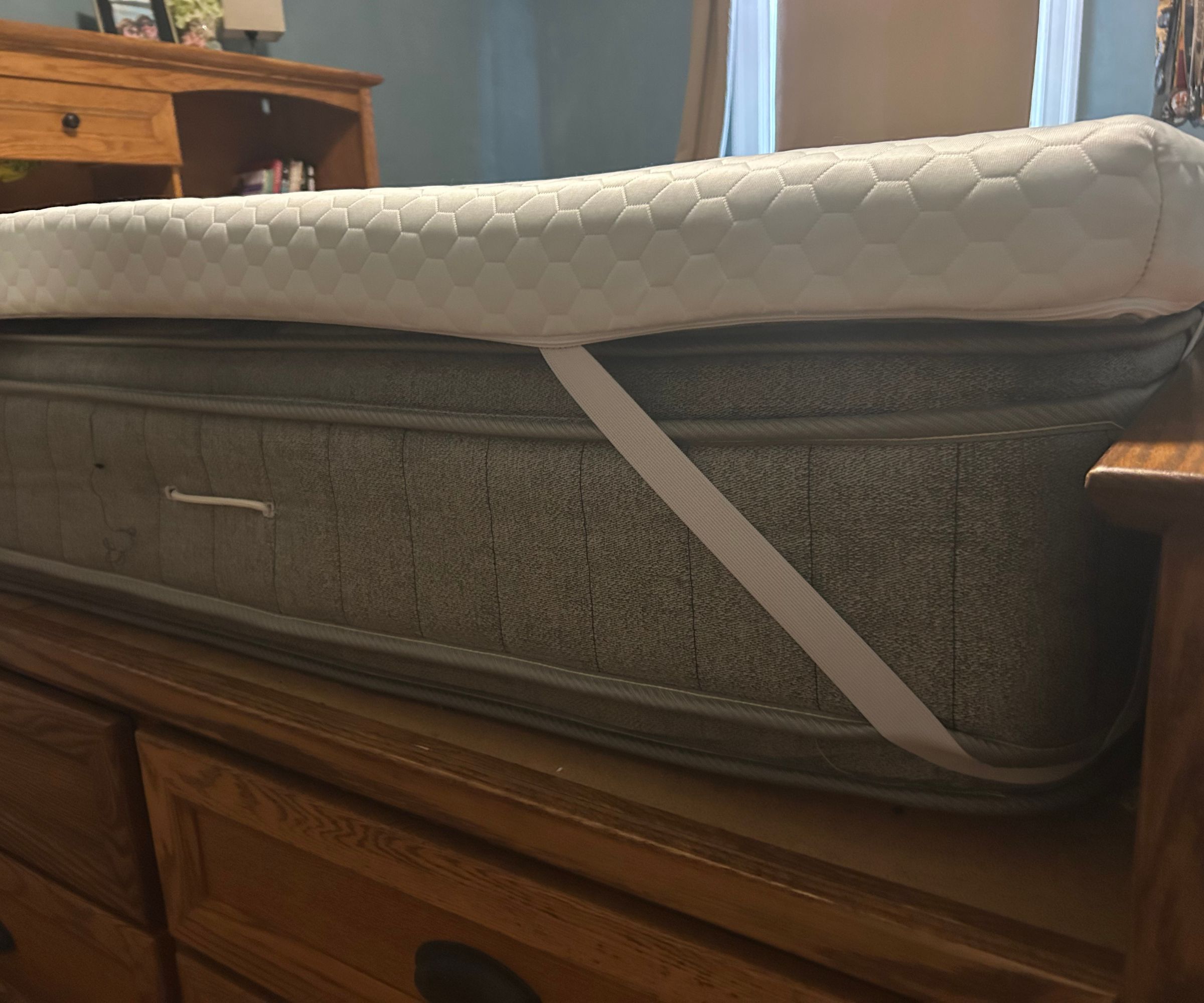 Corner of the Helix ErgoAlign Mattress Topper on a bed.
