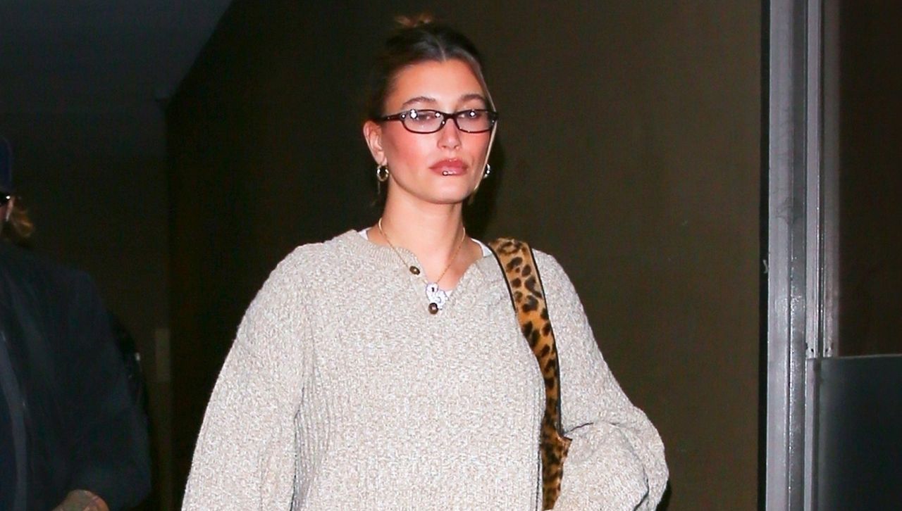 Hailey Bieber wearing cozy fall basics and a leopard bag on her wedding anniversary