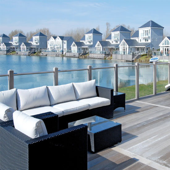 decking area with sofa and lake view