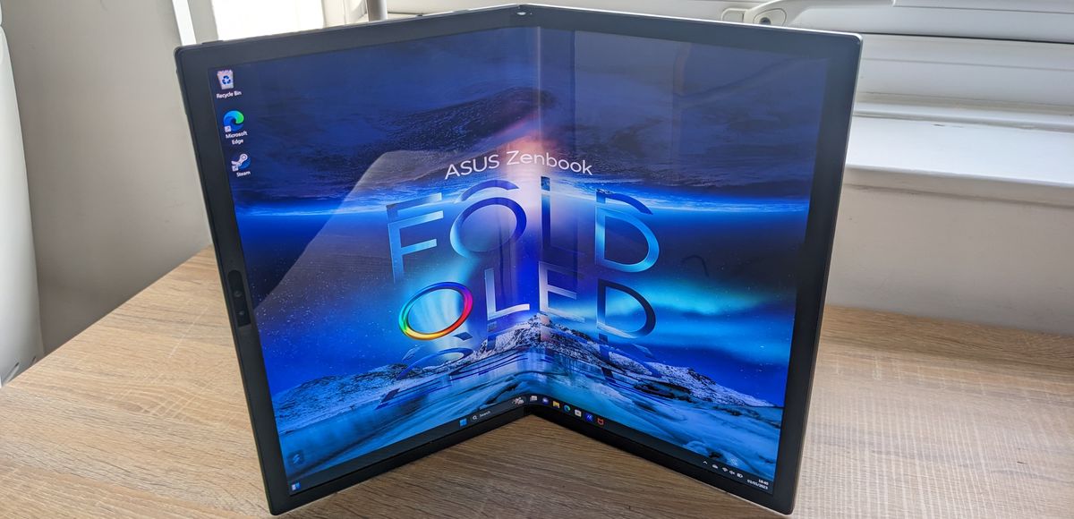 The Asus Zenbook 17 Fold OLED pictured on a wooden desk.