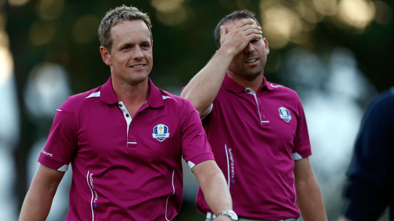 Luke Donald and Sergio Garcia walk alongside each other