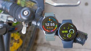 Samsung Galaxy Watch 7 next to a Google Pixel Watch 3 on a bike handlebar