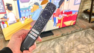 TCL QM8 remote with buttons for Netflix, Prime Video, YouTube, Apple TV and Pluto TV.