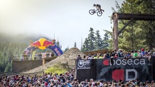 A rider performs a tailwhip drop at Whistler Joyride in 2015