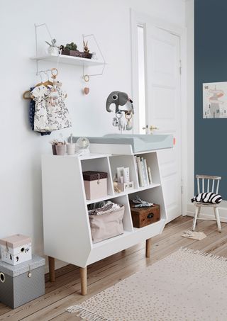 Changing table and storage unit in baby's room by Urban Avenue