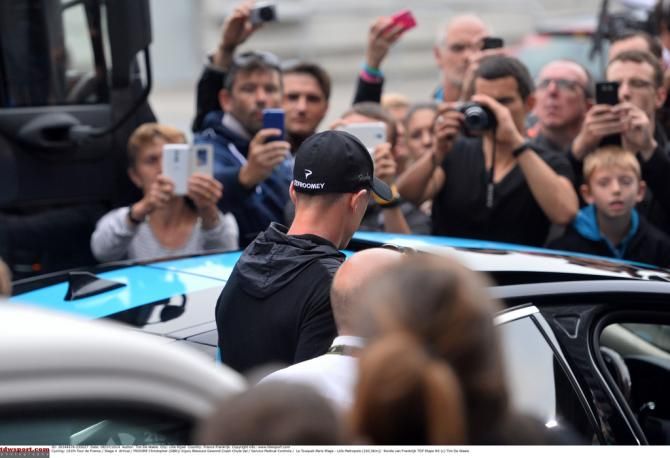 A sore Chris Froome gets into a Team Sky car