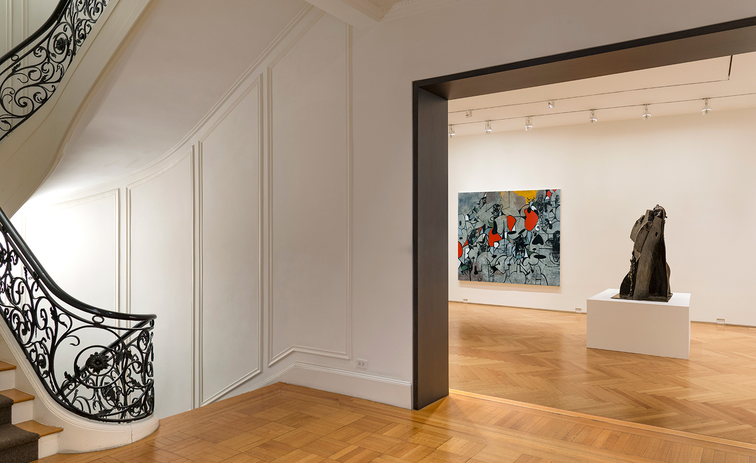 Upstairs in the South Gallery, four paintings of anonymous crowds comment on the current state of politics as they surround a bronze sculpture