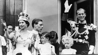 Queen Elizabeth II, Prince Philip, Duke of Edinburgh and their children, Prince Charles and Princess Anne, wave from the balcony