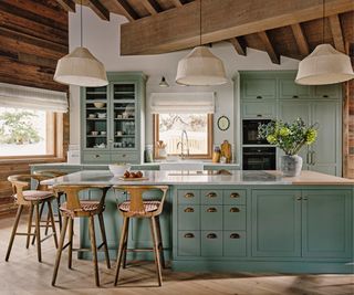 Cabin kitchen with green cabinetry