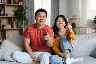 Asian couple watching TV