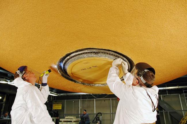 Shuttle Fuel Tank Workers Ding Foam Insulation