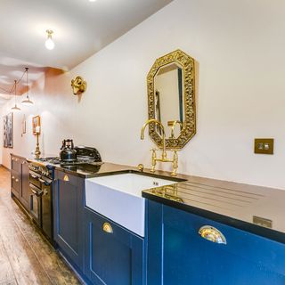 kitchen with black range cooker and cobalt blue cabinets