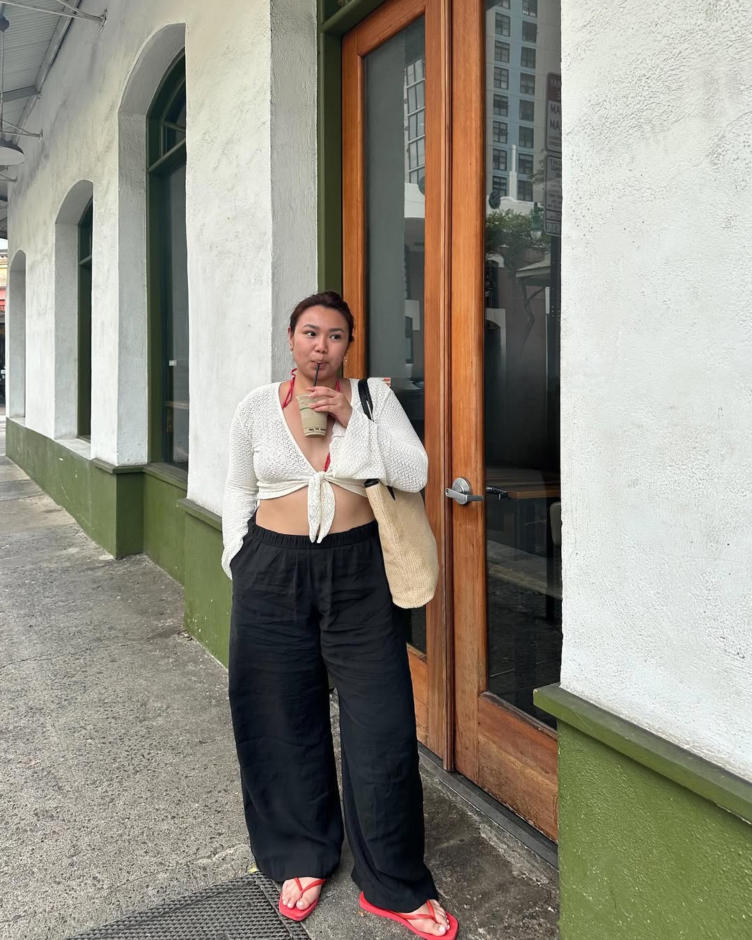 fashion influencer in black trousers and white tie-front top