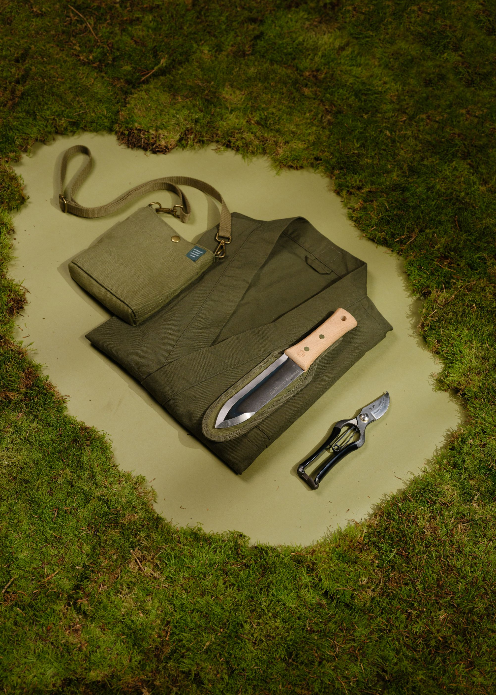 The whole collaboration collection is displayed in a clearing of moss