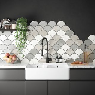 Charcoal kitchen cabinets with fishscale tile backsplash in gray and white