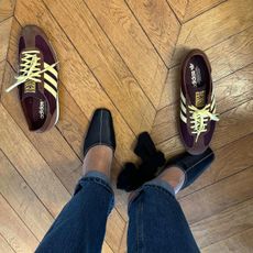 @annelauremais trying on Adidas SL72 sneakers and black mules on a wood floor.