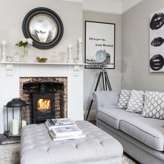living room with white wall stove and grey sofa
