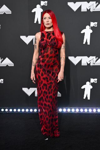 Halsey wearing a red leopard dress by Versace to the 2024 VMAs red carpet