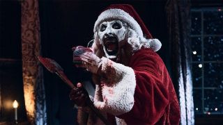 Art The Clown dressed as santa covered in blood In Terrifier 3