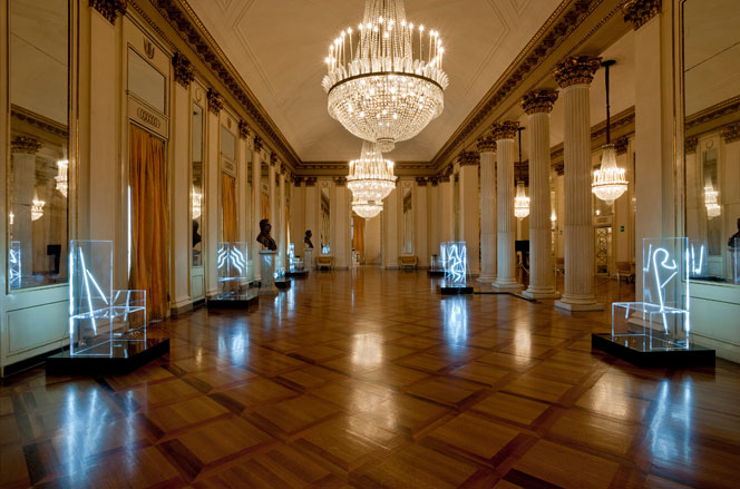 Large hall with hanging chandeliers and several electric chairs