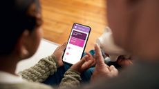 Girl and father look at an online banking app on a phone