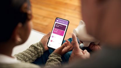 Girl and father look at an online banking app on a phone
