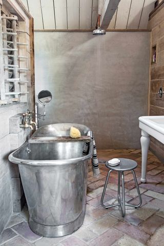 Rustic bathroom with brick floor tiles