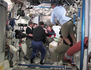 Atlantis' Crew Hugs ISS Crew