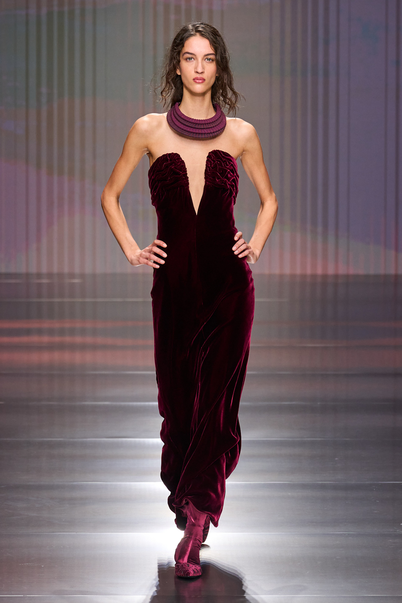 a woman walks the giorgio armani fall/winter 2026 show.