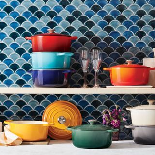 Colorful collection of Le Creuset dutch ovens in kitchen