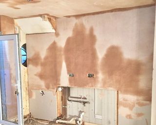fresh plaster drying on kitchen walls during renovation