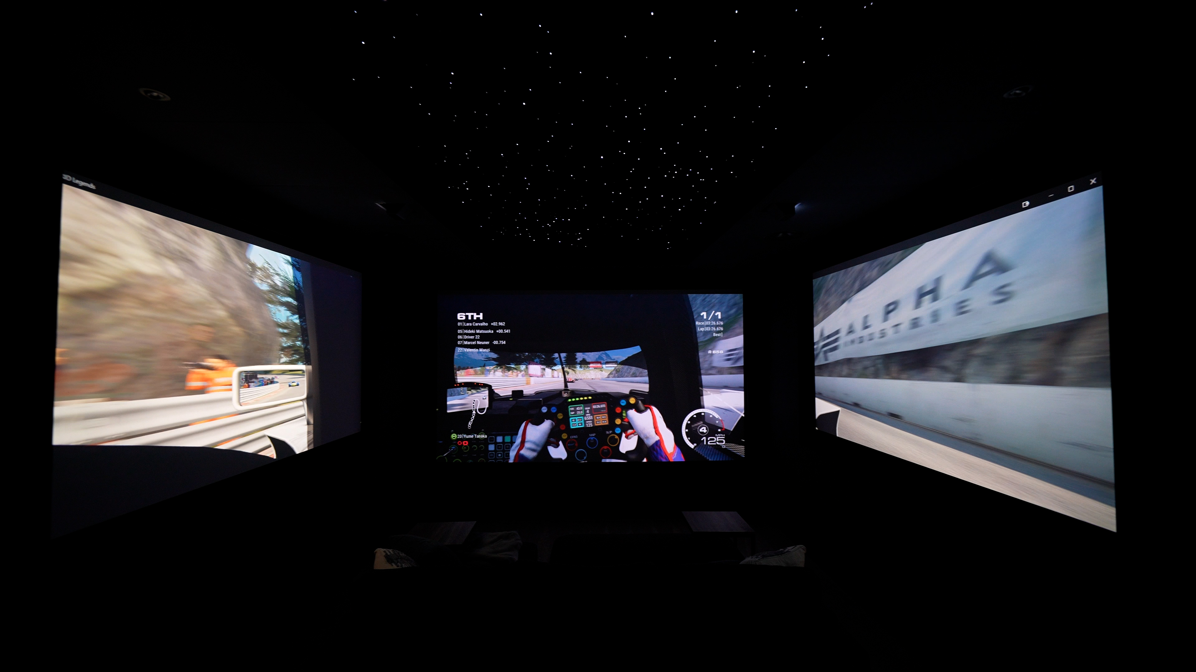 images of The Ultimate Home Theater Gaming Setup theater showing three projection screens, sofas and gaming peripherals