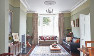 victorian living room with bay window, sofas and plasterwork