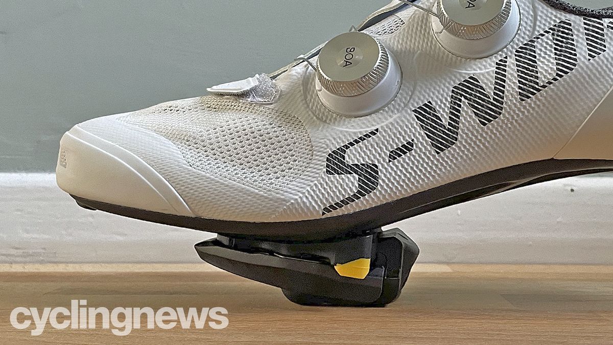 A close up side-on view of a shoe clipped into the Shimano 105 pedals, showing the overall stack height