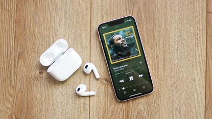 the apple airpods 3rd generation next to an iphone 13 mini