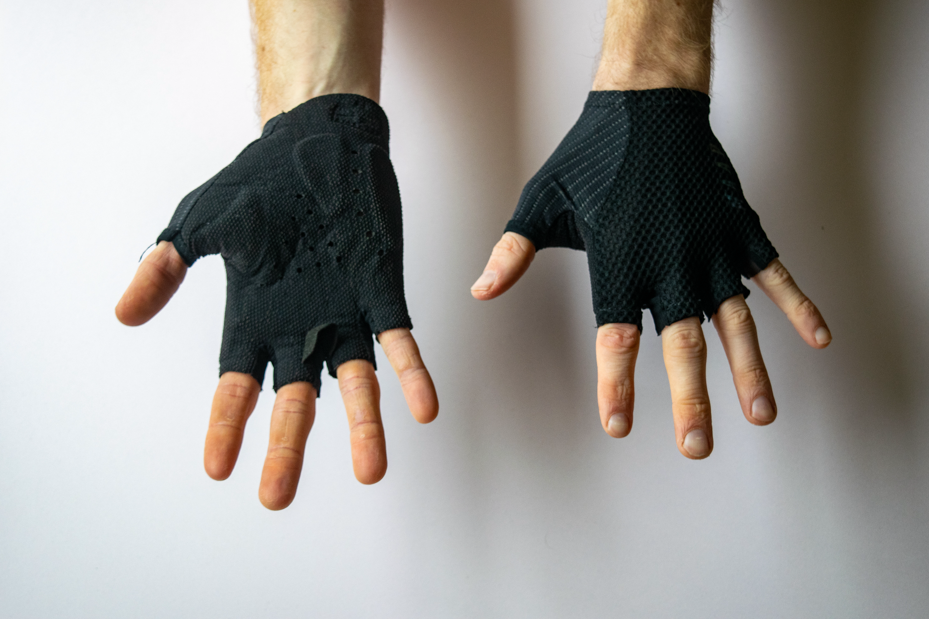 A rider wearing MAAP Pro Race Mitts with hands showing the palm and face of the gloves