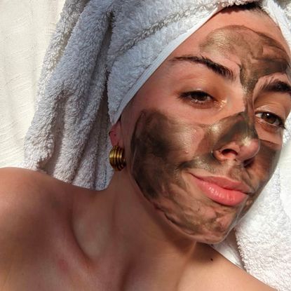 Acting Senior Beauty Editor Shannon Lawlor wearing a grey mud mask