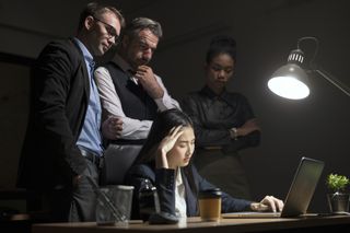 Shot of a young businesswoman looking anxious in a demanding office environment at night