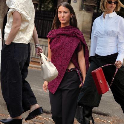 Collage of draped and asymmetric tops in white, cream, black, and burgundy, styled with skirts, trousers, and jeans.