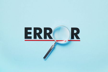 the word error with a magnifying glass over the letter o