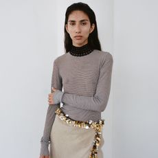 woman posing in a sheer top and an embellished skirt from Diotima's Spring 2025 collection 