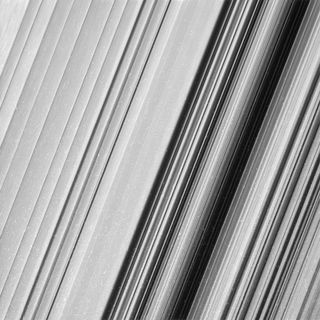 Cassini took this image of Saturn's outer B ring in visible light, revealing even more fine detail to be explored, NASA officials said. The bright marks are caused by cosmic rays and charged particles near the planet.
