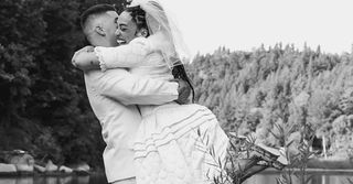 Black and white photo of wedding couple hugging.