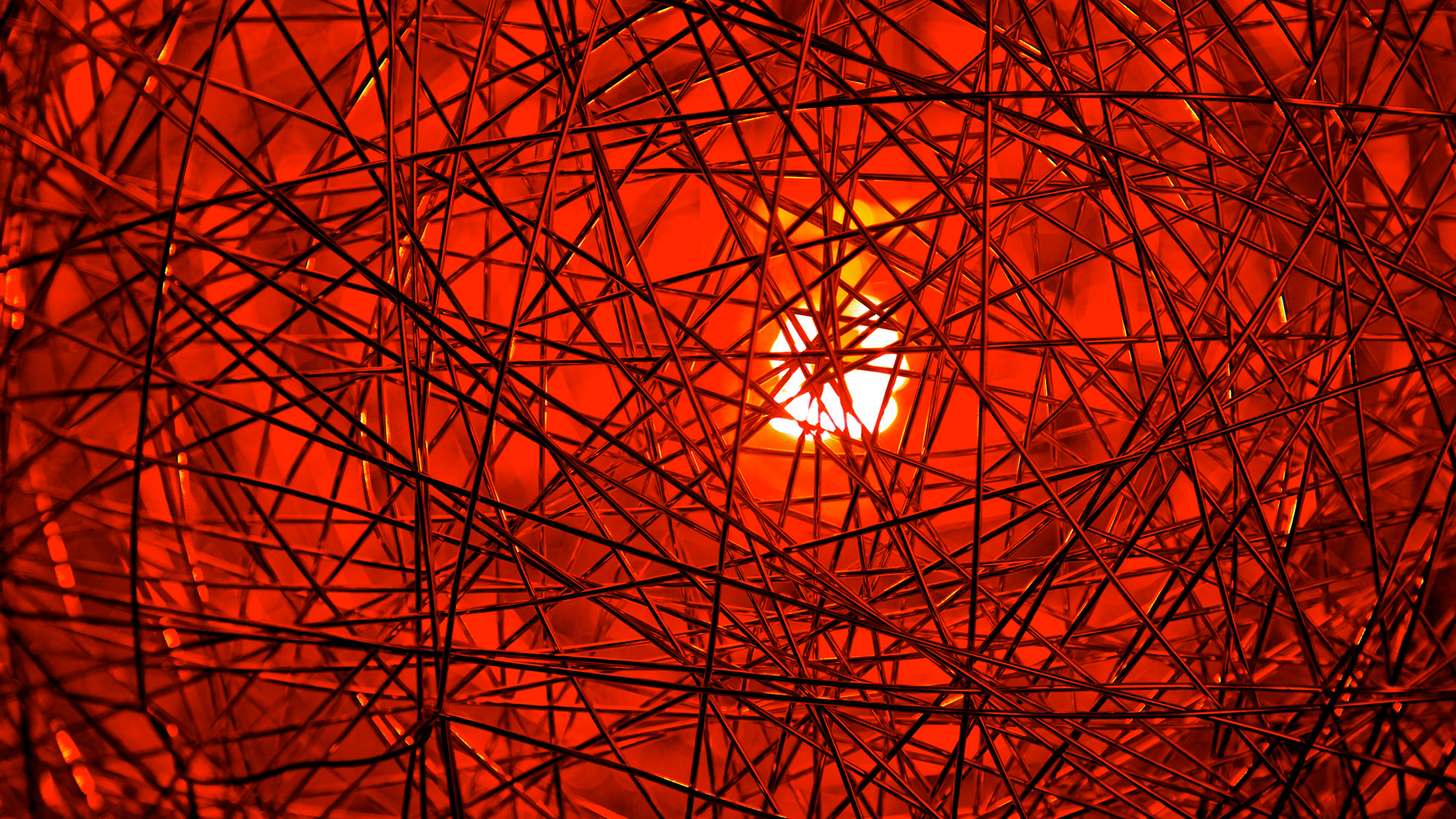 A series of fibers against a glowing red background
