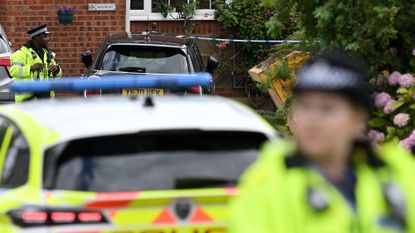 Police stand guard in Bushey, Hertfordshire