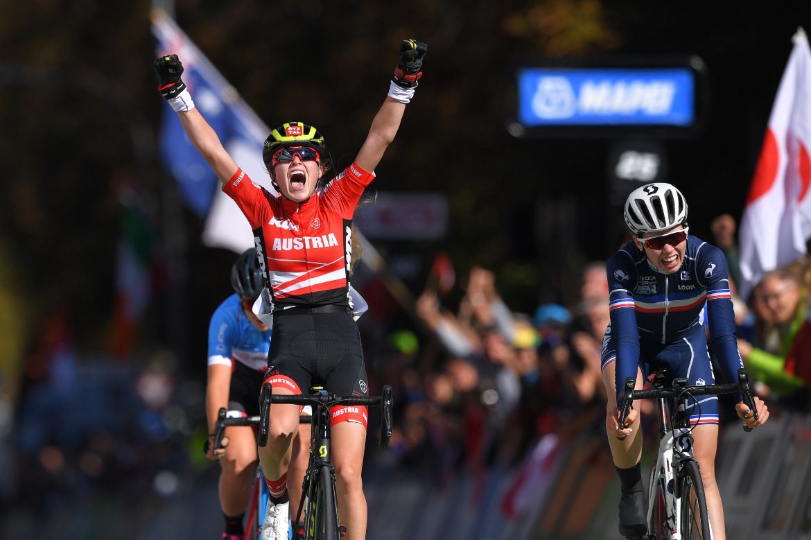 Laura Stigger raises her arms in celebration